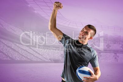 Composite image of cheerful rugby player punching the air