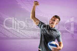 Composite image of cheerful rugby player punching the air