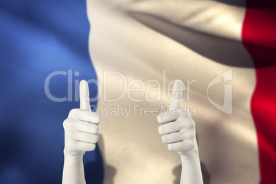 Composite image of businesswomans hands showing thumbs up