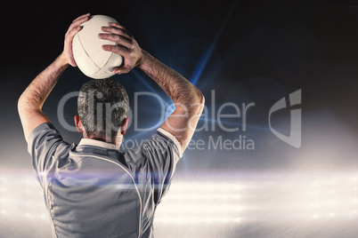 Composite image of rugby player about to throw a rugby ball