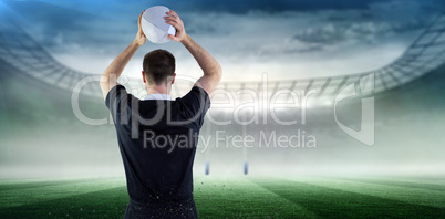 Composite image of rugby player about to throw a rugby ball