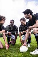 Rugby players discussing their tactics
