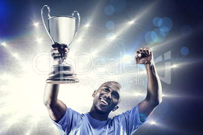 Composite image of happy sportsman looking up and cheering while