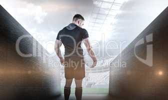 Composite image of tough rugby player holding ball