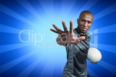 Composite image of close-up portrait of sportsman gesturing while standing with rugby ball