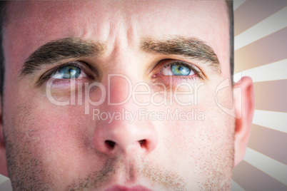 Composite image of tough rugby player looking away