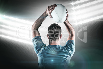 Composite image of rear view of rugby player throwing ball