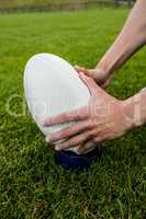 Rugby player picking up ball