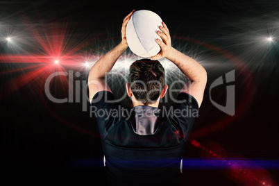 Composite image of back turned rugby player throwing a ball