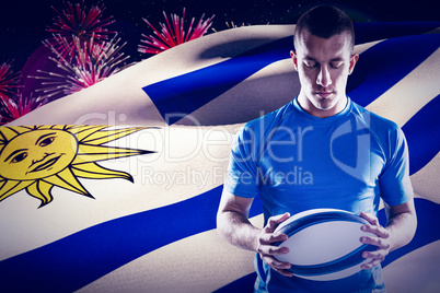 Composite image of thoughtful rugby player holding ball