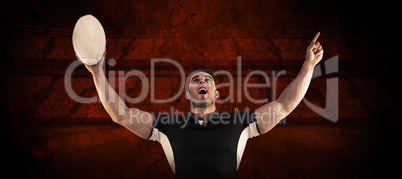 Composite image of rugby player cheering with the ball