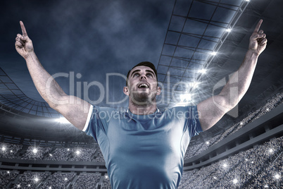 Composite image of rugby player cheering and pointing