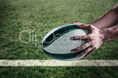 Composite image of cropped image of sports player holding ball