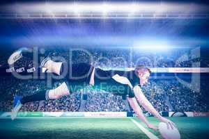 Composite image of a rugby player scoring a try