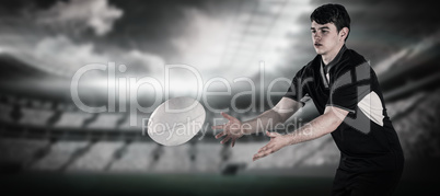 Composite image of rugby player throwing a rugby ball