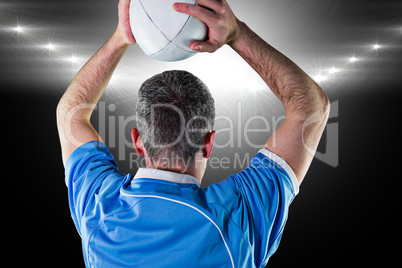 Composite image of rugby player about to throw a rugby ball