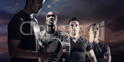 Composite image of calm rugby player thinking while holding ball