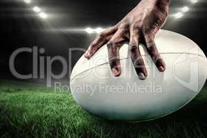 Composite image of cropped image of sportsman holding rugby ball