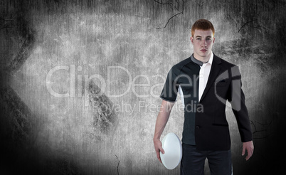 Composite image of rugby player holding a rugby ball