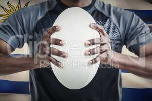 Composite image of cropped image of sportsman pressing rugby bal