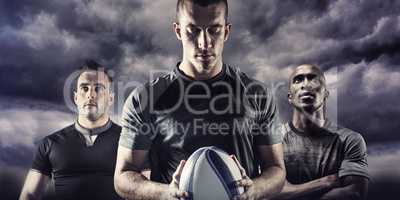 Composite image of thoughtful rugby player holding ball