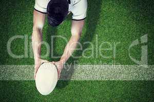 Composite image of high angle view of man holding rugby ball wit