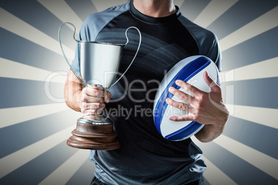 Composite image of midsection of successful rugby player holding