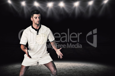 Composite image of rugby player taking position