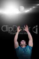 Composite image of rugby player catching the ball