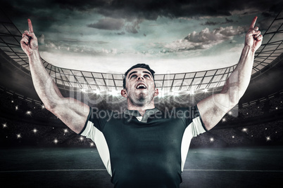 Composite image of rugby player cheering and pointing