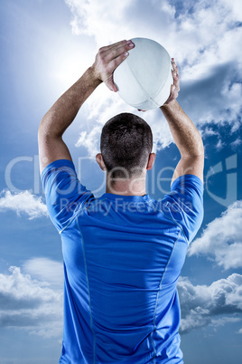 Composite image of rear view of rugby player throwing ball