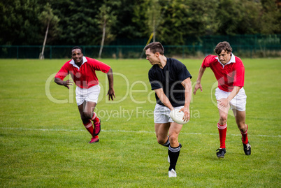 Rugby players running during game