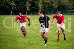 Rugby players running during game