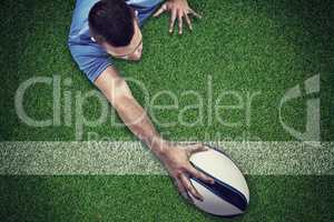 Composite image of rear view of rugby player lying in front with