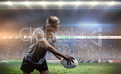 Composite image of sportsman playing rugby