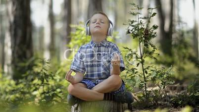 Little Boy Meditating In The Forest