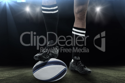 Composite image of rugby player in black socks on ball