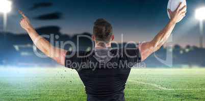 Composite image of rugby player celebrating with the ball