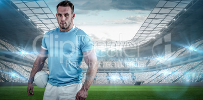 Composite image of rugby player looking at camera