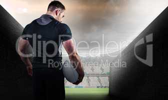 Composite image of tough rugby player holding ball