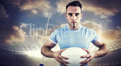 Composite image of rugby player looking at camera