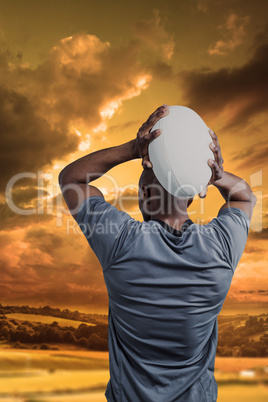 Composite image of rear view of sportsman throwing rugby ball