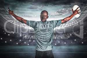 Composite image of rear view of athlete with arms raised holding