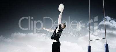 Composite image of rugby player catching a rugby ball