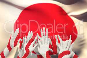 Composite image of people raising hands in the air