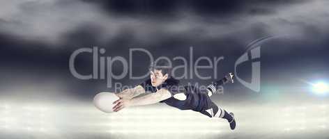 Composite image of a rugby player scoring a try