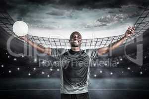 Composite image of confident athlete with arms raised holding ru