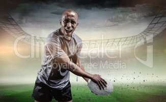 Composite image of portrait of aggressive sportsman playing rugb