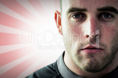 Composite image of tough rugby player looking at camera