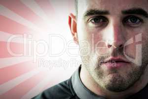 Composite image of tough rugby player looking at camera